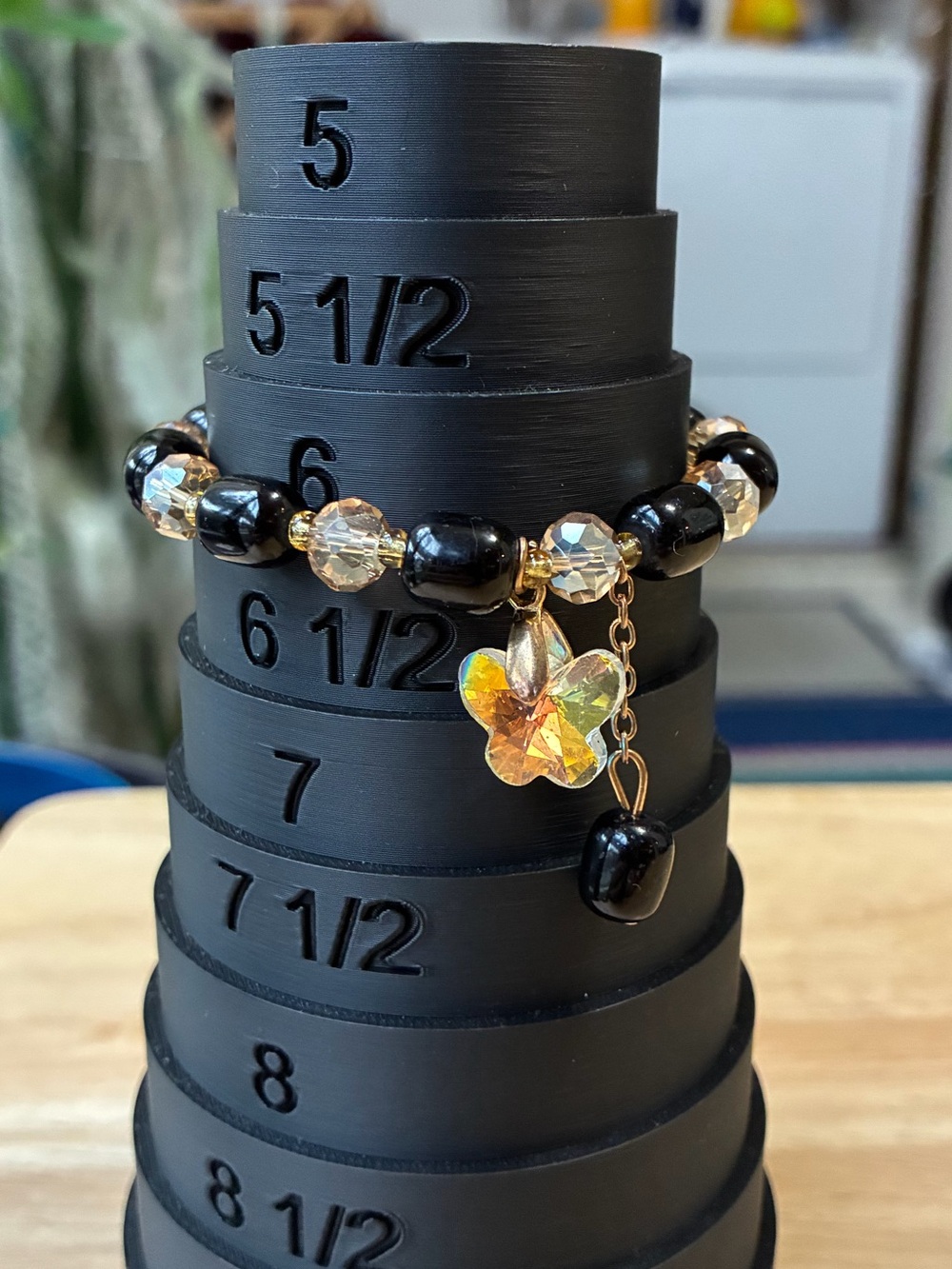 Black and Gold Beaded Stretch Bracelet with Iridescent Flower Charm - Picture 5 of 9